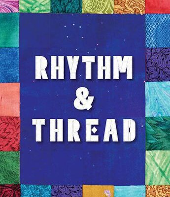 A patchwork quilt with colorful fabric squares surrounds a blue center with white text that reads "Rhythm & Thread.