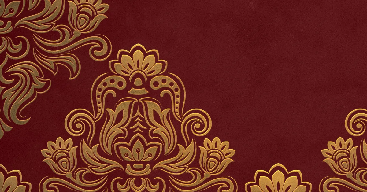Gold floral ornamental pattern on a maroon background, with intricate symmetrical designs concentrated on the left side of the image.