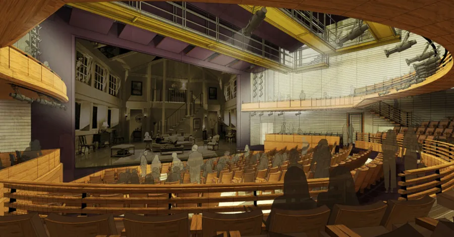 A modern theater auditorium with wooden seating, a large stage featuring a detailed set, and lighting equipment overhead.