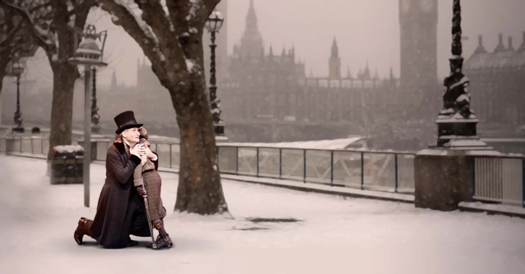 A man kneeling on a snowy sidewalk holding a baby.
