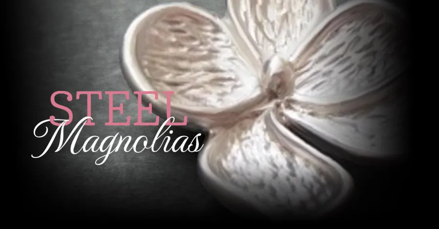 A metallic magnolia flower with the text "Steel Magnolias" overlayed in pink and white on a dark background.