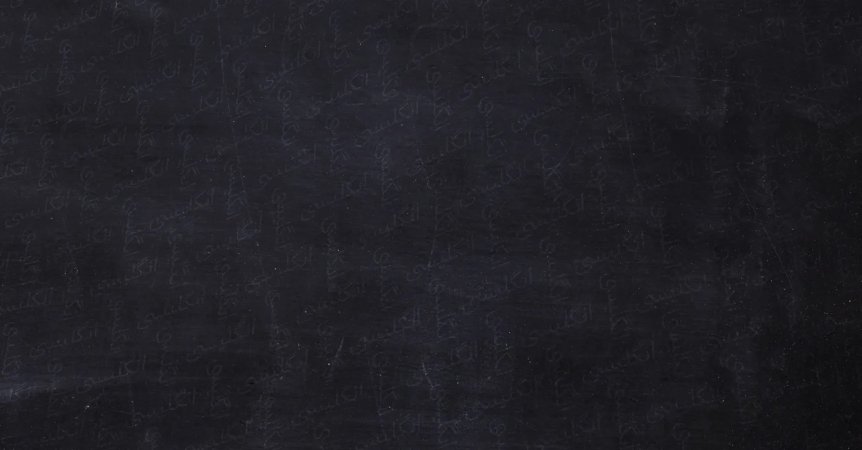 A blank, dark blackboard with faint chalk marks and smudges visible across the surface.