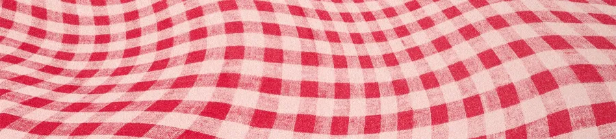 A red and white gingham fabric with a wavy, undulating surface pattern.