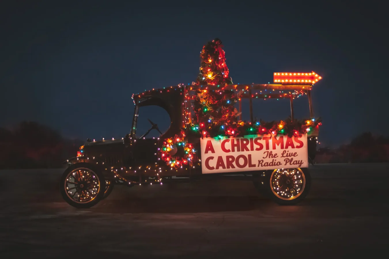 A car decorated with lights and a sign.