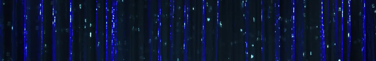Vertical blue light streaks with small glowing dots on a dark background, creating an abstract, digital or futuristic effect.