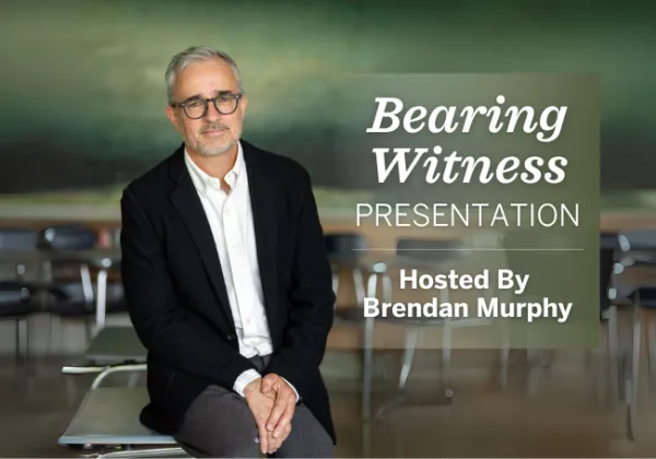 A man in a suit sits on a desk in a classroom. Text reads: "Bearing Witness Presentation. Hosted By Brendan Murphy.