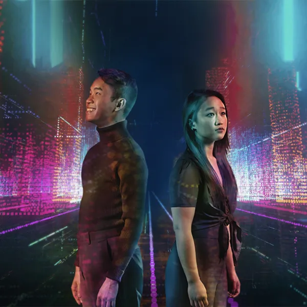 A man and a woman stand back-to-back in front of a neon-lit, futuristic digital cityscape with vivid pink, blue, and purple hues.