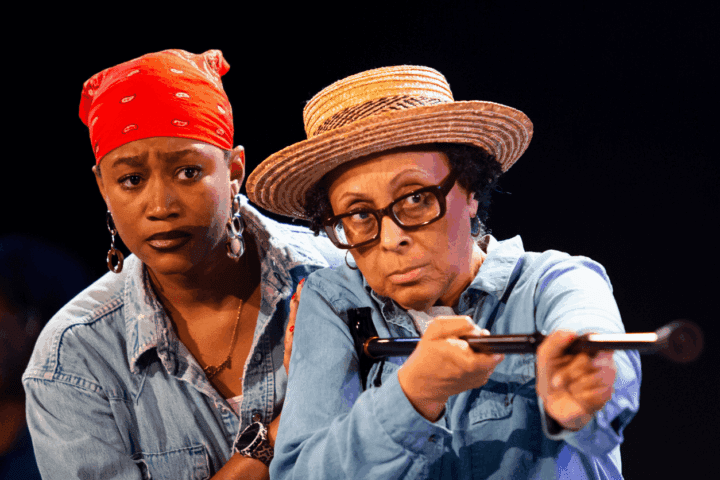 Three stage scenes: a performer gestures before a projected face, dancers in costume pose mid-performance, and two actors in hats and costumes, one aiming a prop rifle.