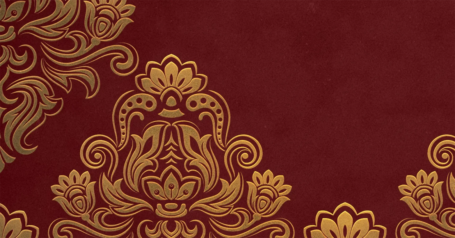 Gold floral ornamental pattern on a dark red background, featuring symmetrical, intricate designs in the upper left and lower right corners.
