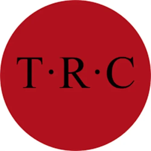 A solid red circle with the black letters "T R C" evenly spaced and separated by dots in the center.