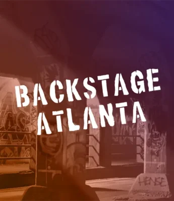 Text "Backstage Atlanta" appears in bold white stencil letters over a background of a graffiti-covered urban structure.