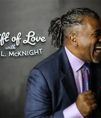 A man in a suit smiles and clasps his hands in excitement beside the text “A Gift of Love with ADAM L. McKNIGHT” on a dark background.