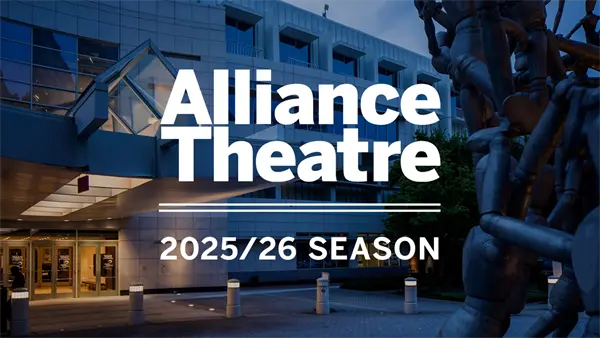 The exterior of Alliance Theatre with bold text announcing the 2025/26 season, displayed in front of the building at dusk.