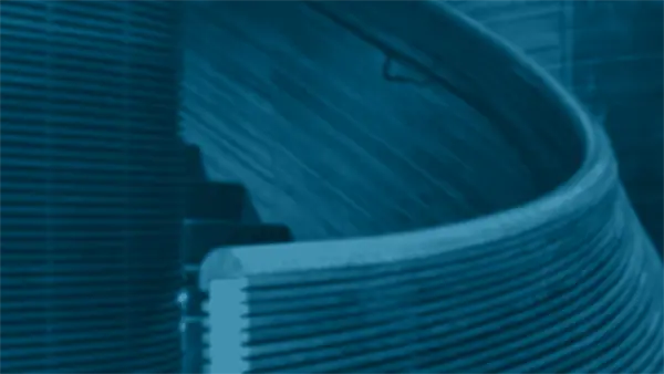 Curved wooden staircase with metal railing, viewed at an angle. The image has a blue monochrome filter.