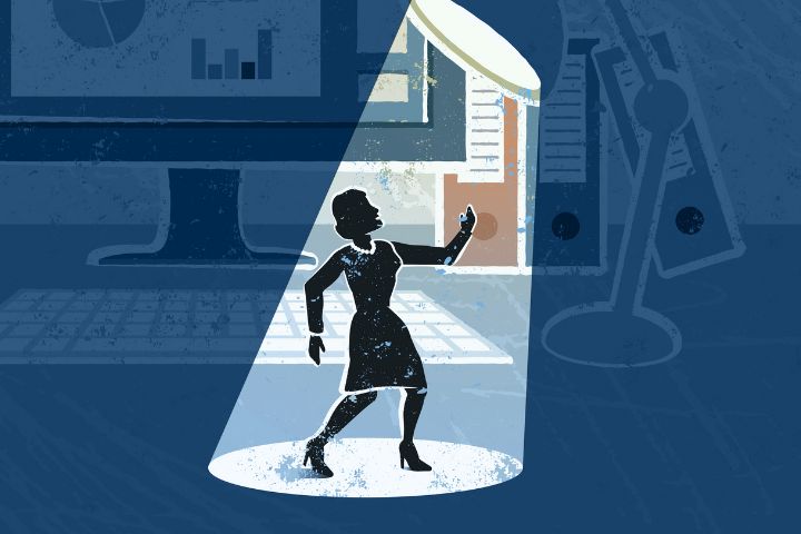 Illustration of a woman standing under a spotlight in an office setting, with a computer monitor, keyboard, and file folders in the background.