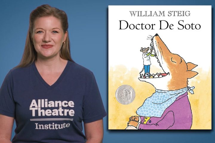 A woman in an "Alliance Theatre Institute" shirt stands next to the book cover of "Doctor De Soto" by William Steig, featuring a mouse dentist working inside a fox's mouth.