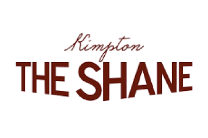 Logo for Kimpton The Shane hotel, featuring "Kimpton" in cursive above bold, capitalized "THE SHANE" on a white background.