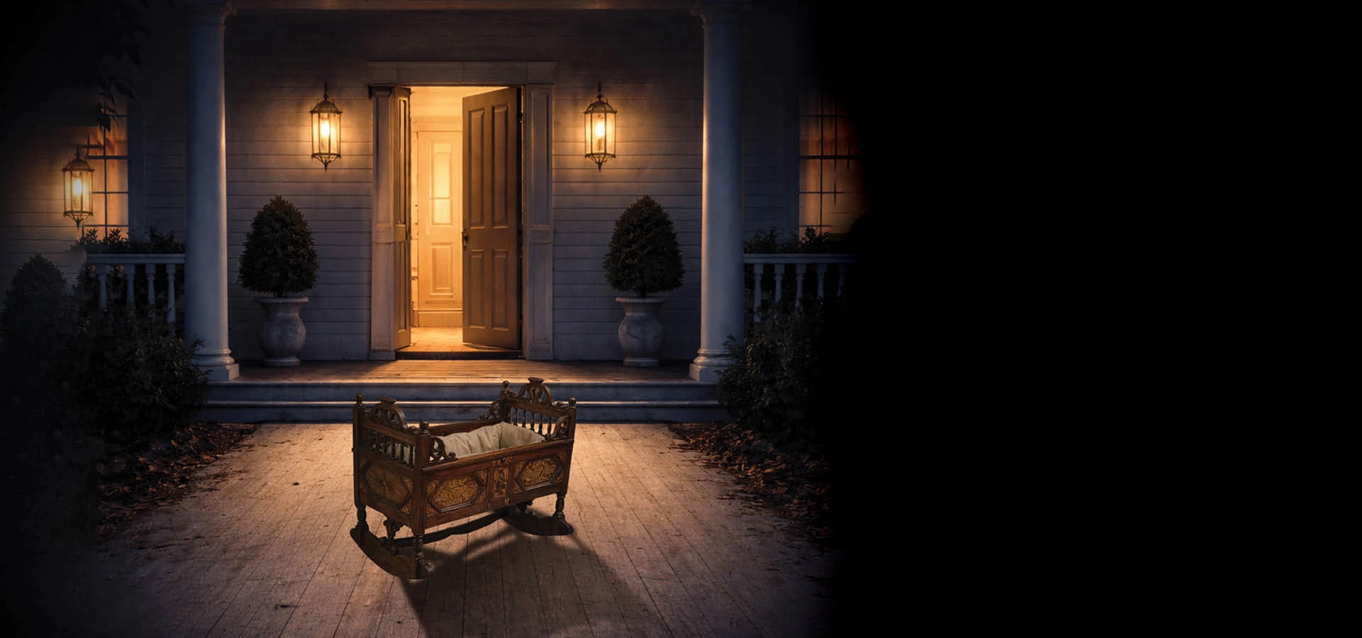 A wooden cradle sits on the porch during The Great Ant Sleepover, with the front door open and warm lights illuminating the entryway at night.