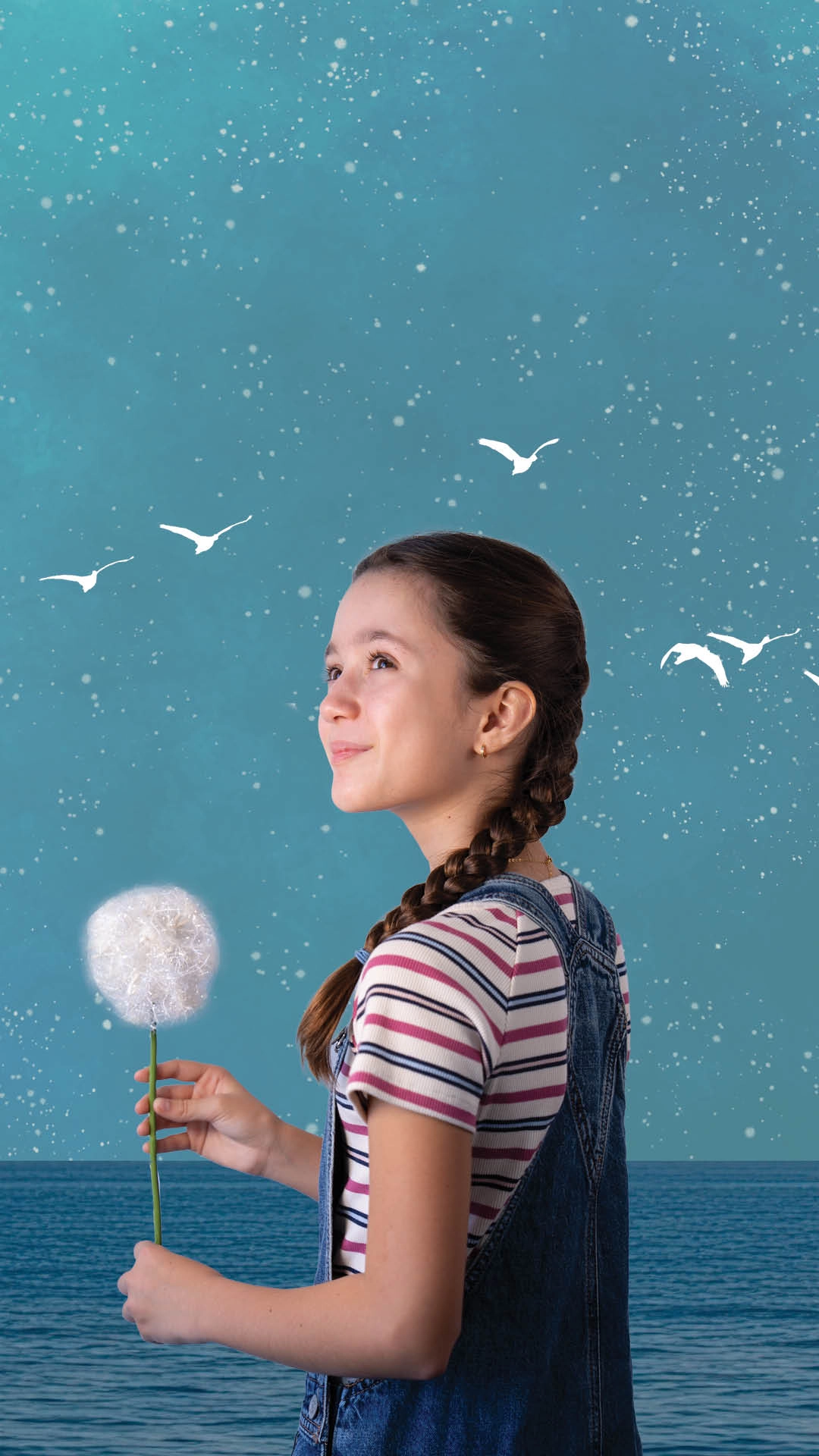 A girl holding a dandelion stands in front of a blue background with white birds and stars, wearing a striped shirt and denim overalls, looking upward and smiling with a sense of purpose.