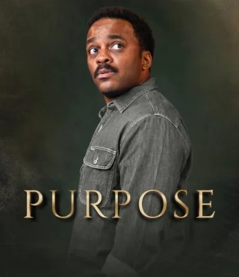 A man in a gray button-up shirt looks over his shoulder against a dark background, embodying a sense of purpose, with the word “PURPOSE” in large gold letters at the bottom.