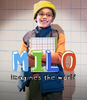 A smiling child wearing glasses, a green beanie, and vest holds a notebook. Text over image reads "MILO imagines the world." Background is a tiled wall—perfect for dreaming up stories about Dinosaur Stream.