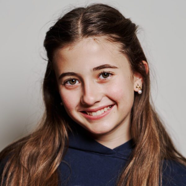 Portrait of a smiling young person with long hair.